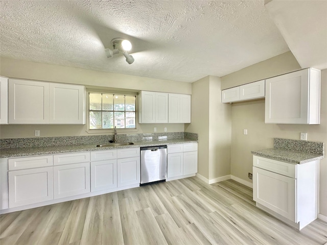 kitchen featuring white cabinets, sink, light hardwood / wood-style floors, a textured ceiling, and dishwasher