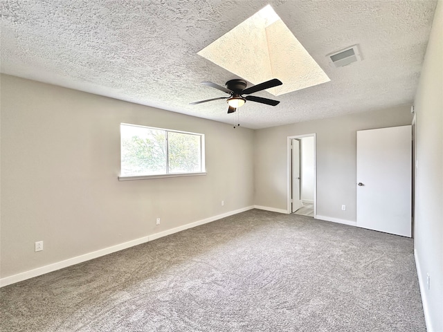 unfurnished room featuring carpet, a textured ceiling, and ceiling fan