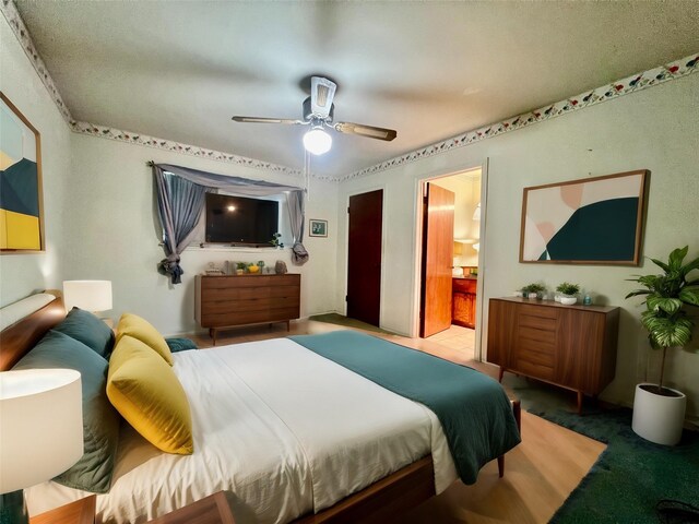 bedroom featuring ensuite bathroom, carpet floors, and ceiling fan