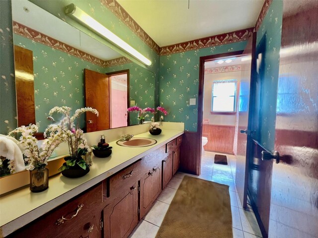 bathroom featuring tile patterned floors, vanity, and toilet