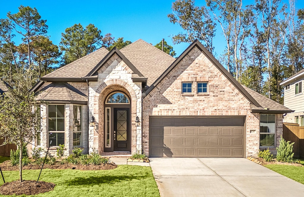 view of front facade with a garage and a front lawn