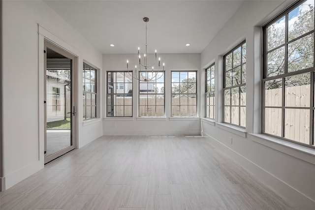 unfurnished sunroom with a chandelier and a healthy amount of sunlight