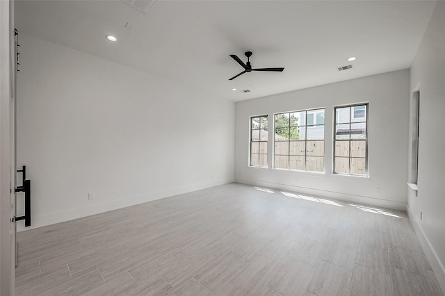 unfurnished room featuring light hardwood / wood-style flooring and ceiling fan