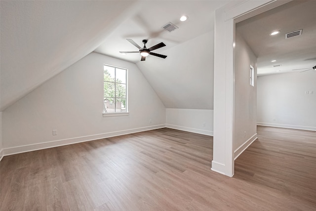 additional living space featuring lofted ceiling, hardwood / wood-style floors, and ceiling fan