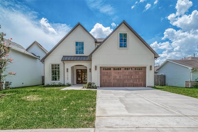 view of front of property with a front yard and a garage