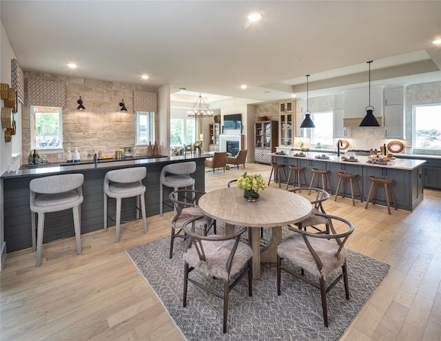 dining room with sink and light hardwood / wood-style flooring