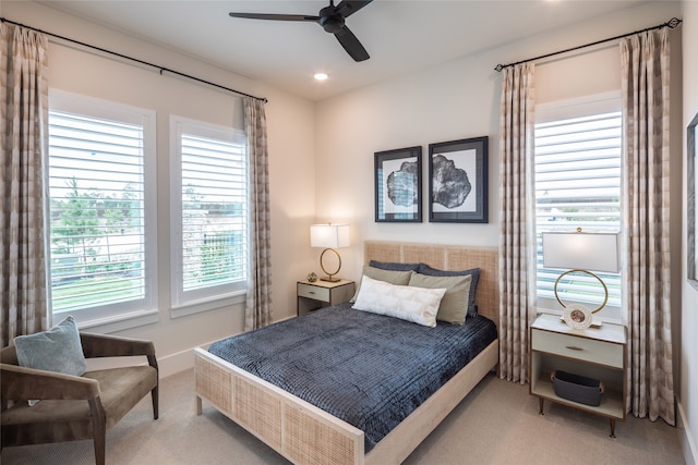 carpeted bedroom with multiple windows and ceiling fan