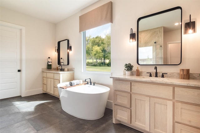 bathroom featuring a freestanding tub, two vanities, baseboards, walk in shower, and a sink