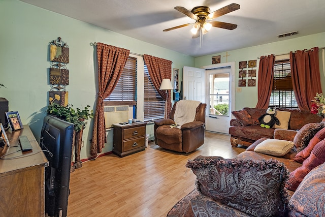 living room with light hardwood / wood-style flooring and ceiling fan