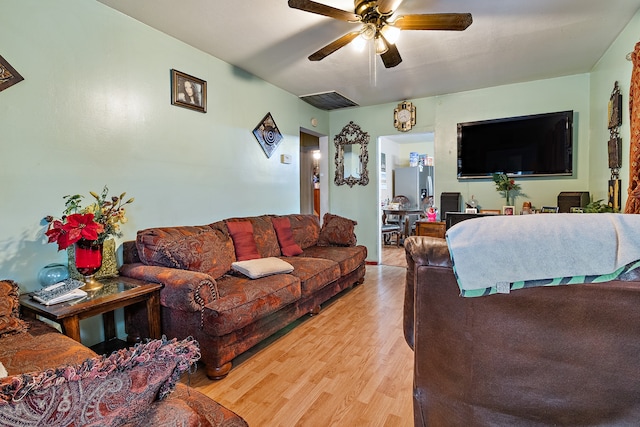 living room featuring ceiling fan and light wood-type flooring