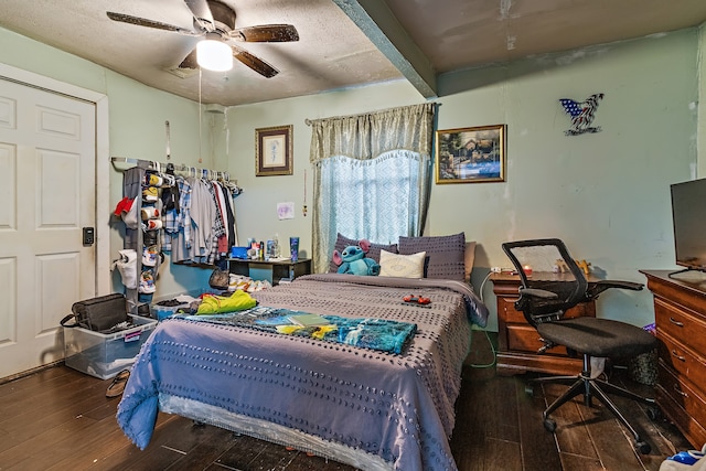 bedroom featuring beamed ceiling, a textured ceiling, ceiling fan, and dark hardwood / wood-style floors