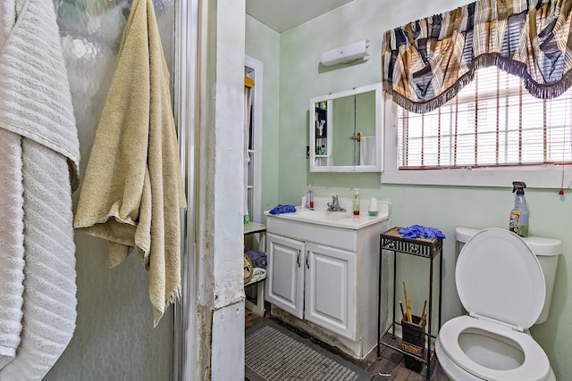 bathroom with vanity, hardwood / wood-style floors, and toilet