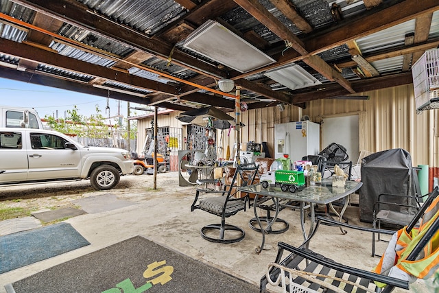 garage with white refrigerator with ice dispenser