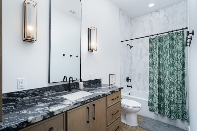 full bathroom featuring hardwood / wood-style floors, shower / bathtub combination with curtain, toilet, and vanity