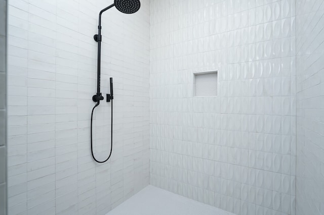 bathroom with tiled shower