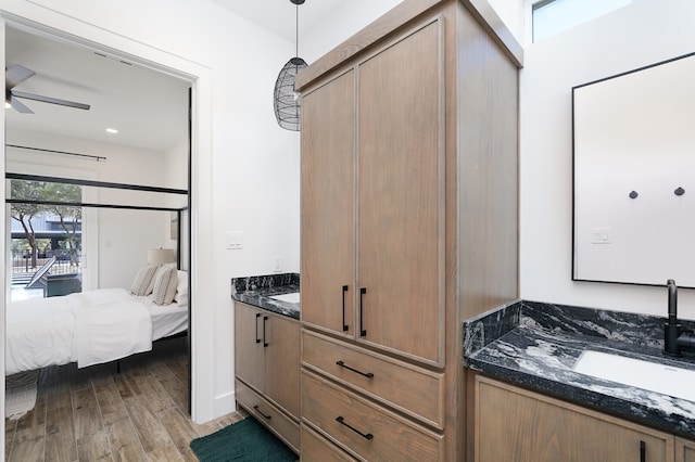 bathroom featuring hardwood / wood-style flooring, vanity, and ceiling fan