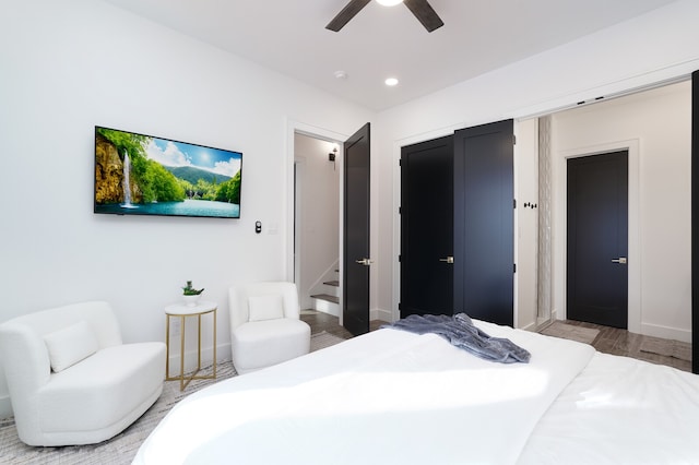 bedroom with ceiling fan and light hardwood / wood-style floors