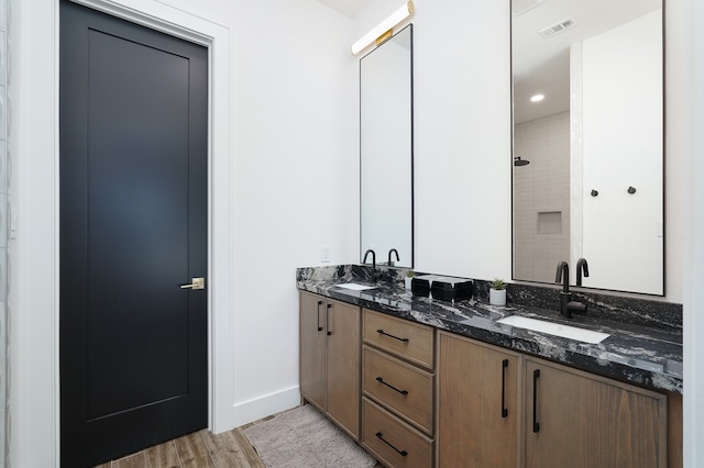 bathroom with wood-type flooring and double sink vanity