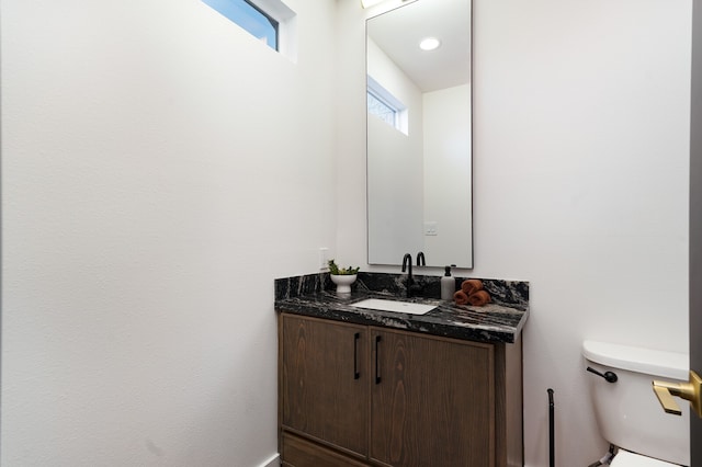 bathroom with toilet and vanity