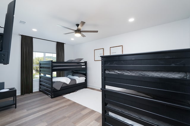 bedroom with light hardwood / wood-style floors and ceiling fan