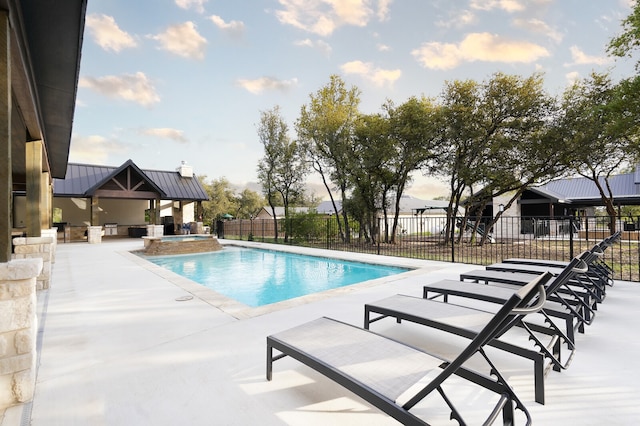 view of pool featuring a patio area and an in ground hot tub