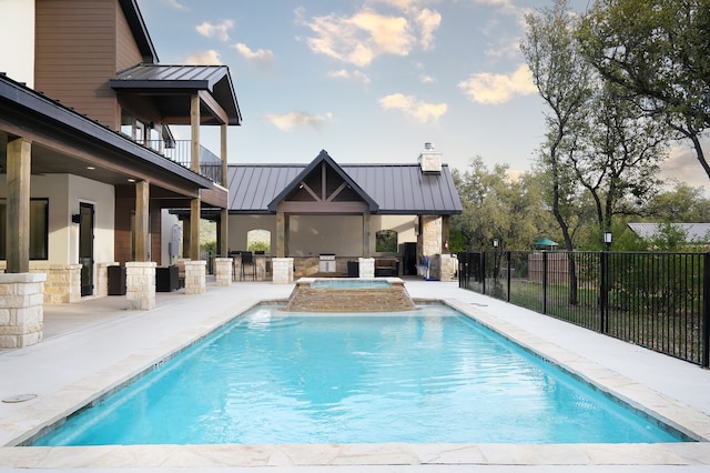 view of pool featuring an in ground hot tub