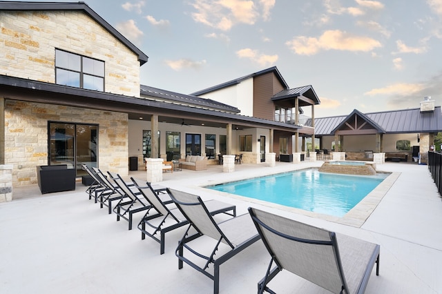 view of swimming pool with a patio and an in ground hot tub