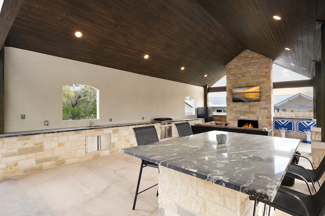 view of patio / terrace with an outdoor stone fireplace