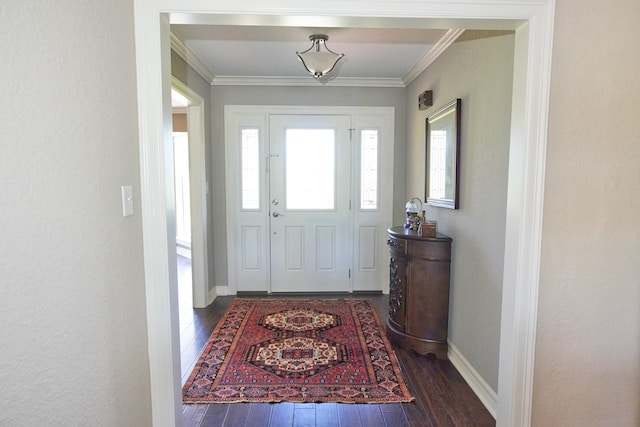 foyer with ornamental molding and dark hardwood / wood-style flooring