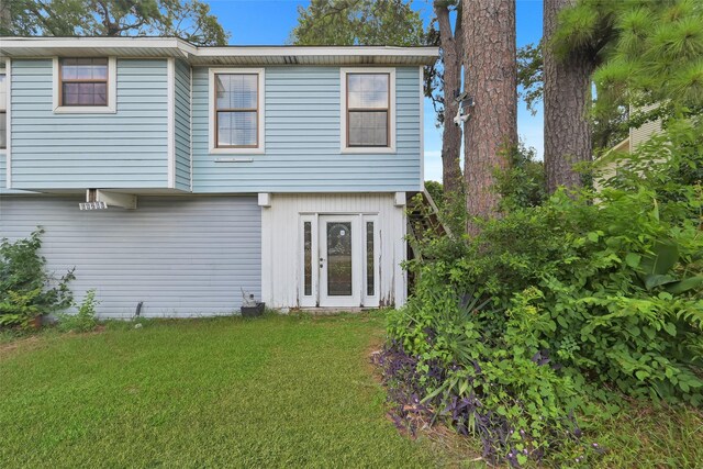 rear view of house featuring a yard