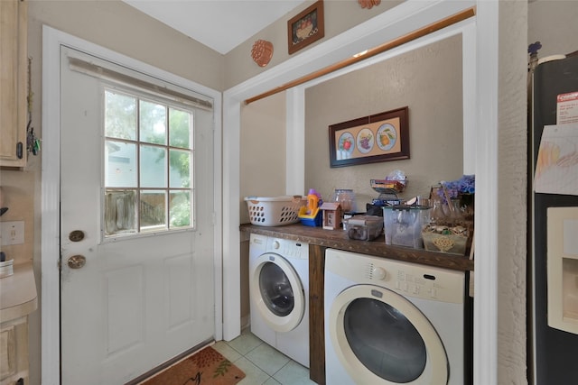 clothes washing area featuring independent washer and dryer and light tile patterned flooring