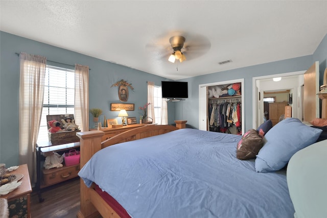 bedroom with ceiling fan, a closet, dark hardwood / wood-style flooring, and multiple windows