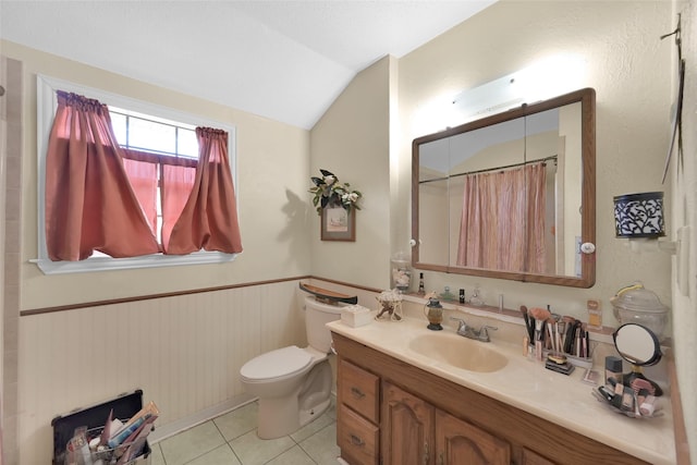 bathroom featuring vanity, vaulted ceiling, tile patterned floors, toilet, and walk in shower