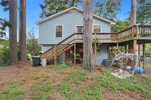 back of house featuring a wooden deck and central air condition unit