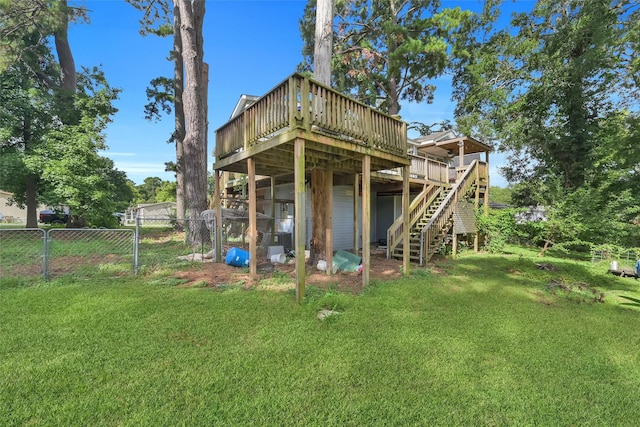 back of house featuring a wooden deck and a yard