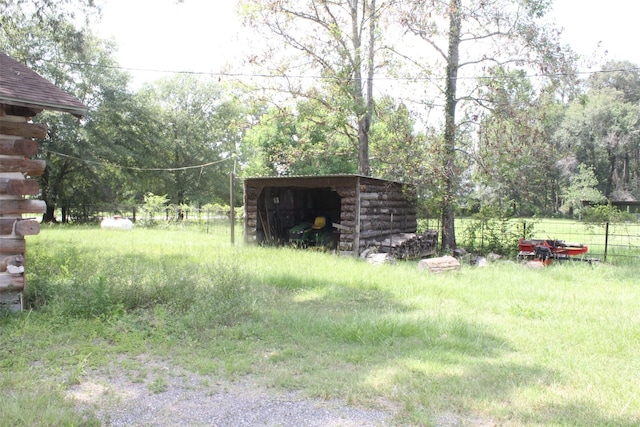 view of yard featuring fence and an outdoor structure