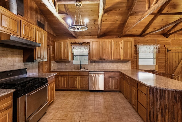 kitchen featuring tasteful backsplash, lofted ceiling with beams, appliances with stainless steel finishes, under cabinet range hood, and a sink