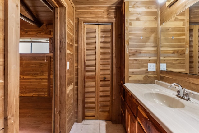 bathroom featuring wood walls, vanity, and tile patterned floors