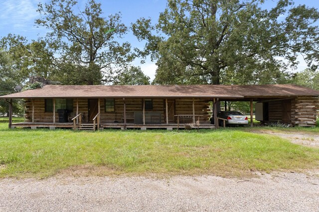 log home featuring covered porch and a carport