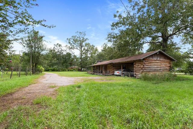 view of yard featuring driveway and a carport