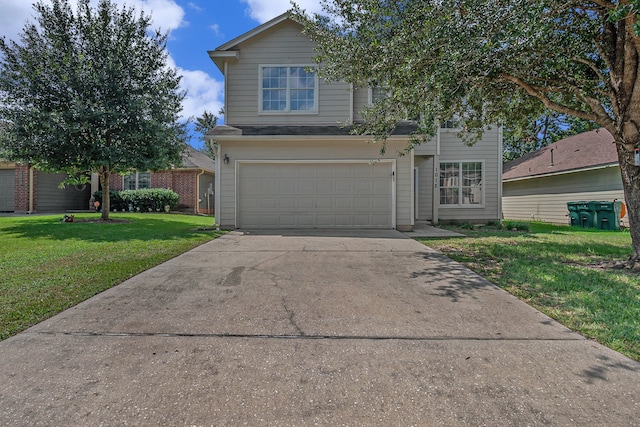 view of property featuring a garage and a front lawn