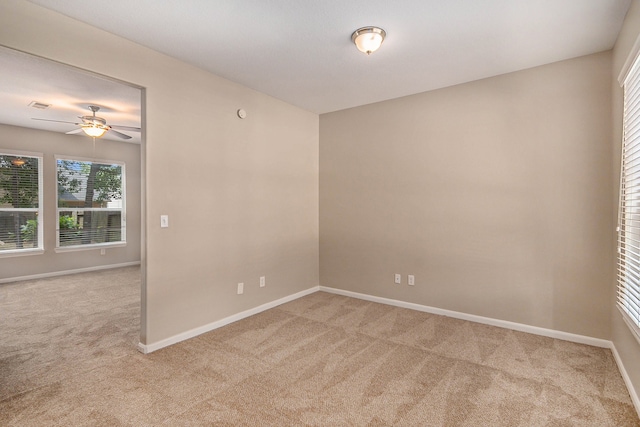 carpeted empty room featuring ceiling fan