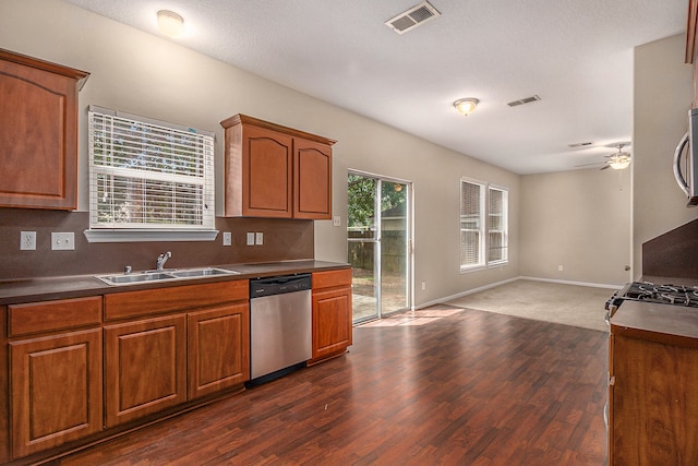 kitchen with dark colored carpet, ceiling fan, sink, and stainless steel appliances