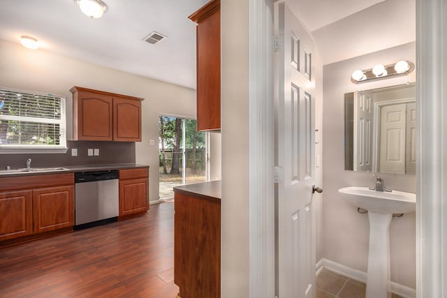 interior space featuring plenty of natural light, decorative backsplash, sink, and wood-type flooring