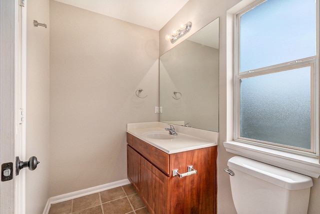 bathroom featuring vanity, tile patterned floors, and toilet