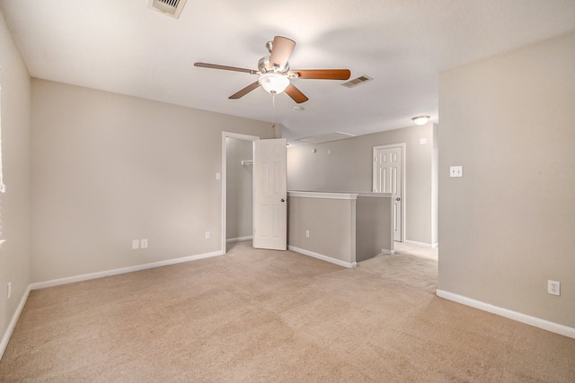 carpeted spare room featuring ceiling fan