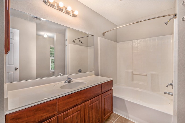 bathroom featuring tile patterned flooring, shower / bathing tub combination, vanity, and a textured ceiling