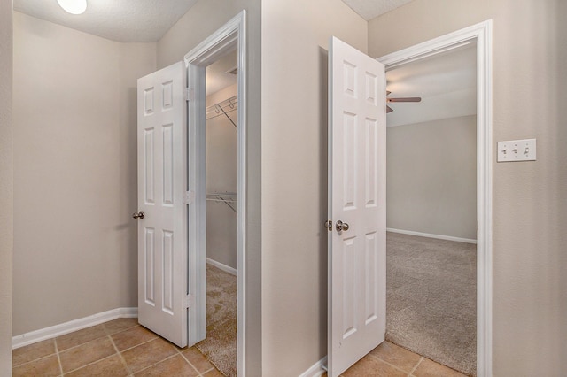 hall with light tile patterned floors