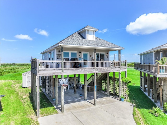 view of front of house featuring covered porch, a carport, and a storage unit