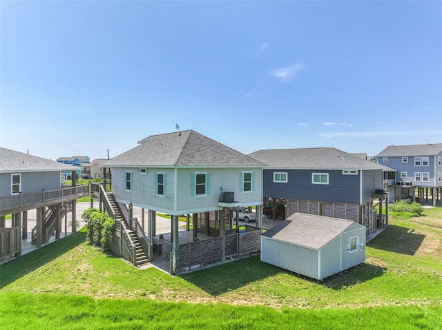 rear view of property featuring a lawn